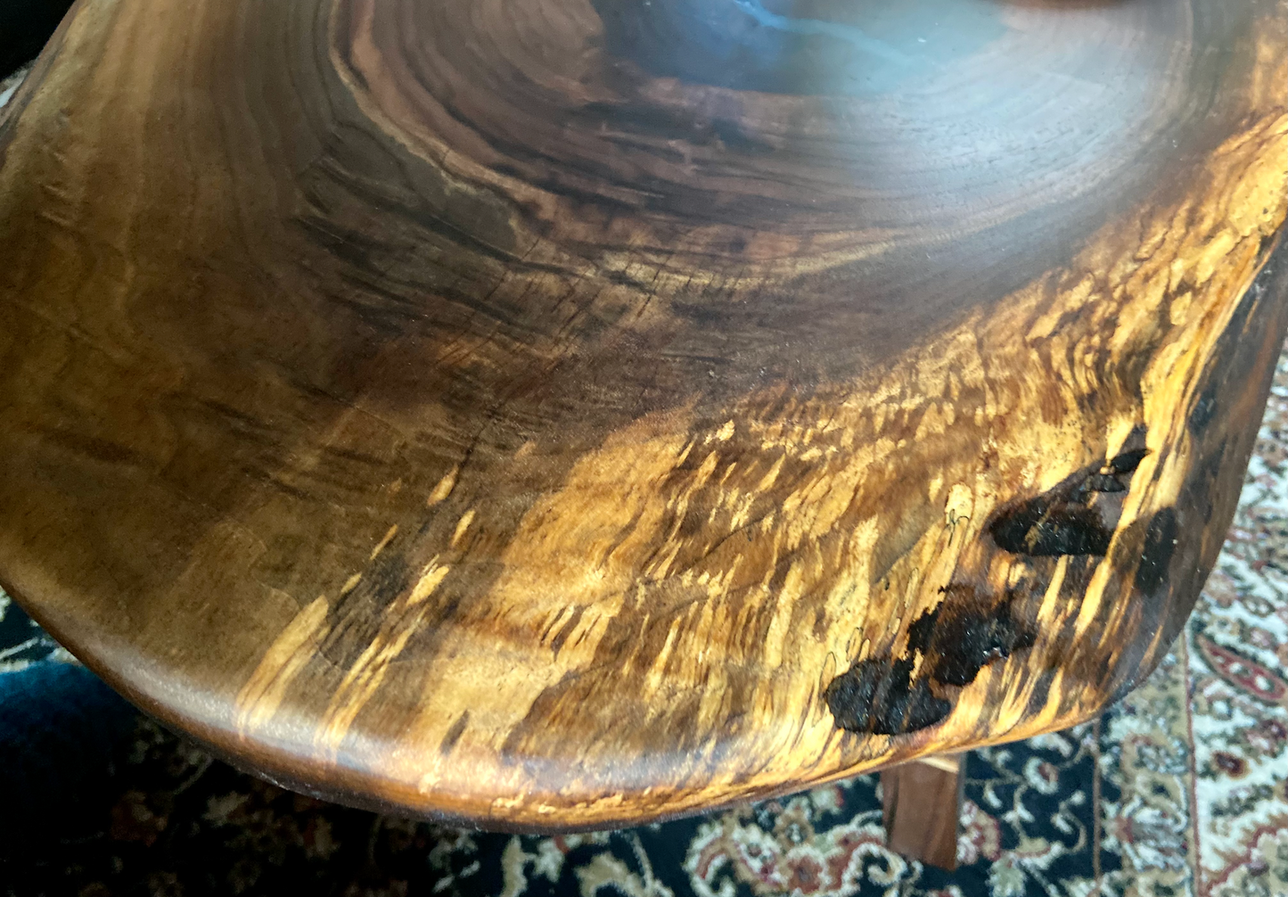 Ultra unique oval rustic natural live edge black walnut coffee table offers natural walnut wood with gorgeous grain patterns, complete with a large knot, a smaller knot, radial grain dancing around the entire table, completed with curl and a long oval shape.