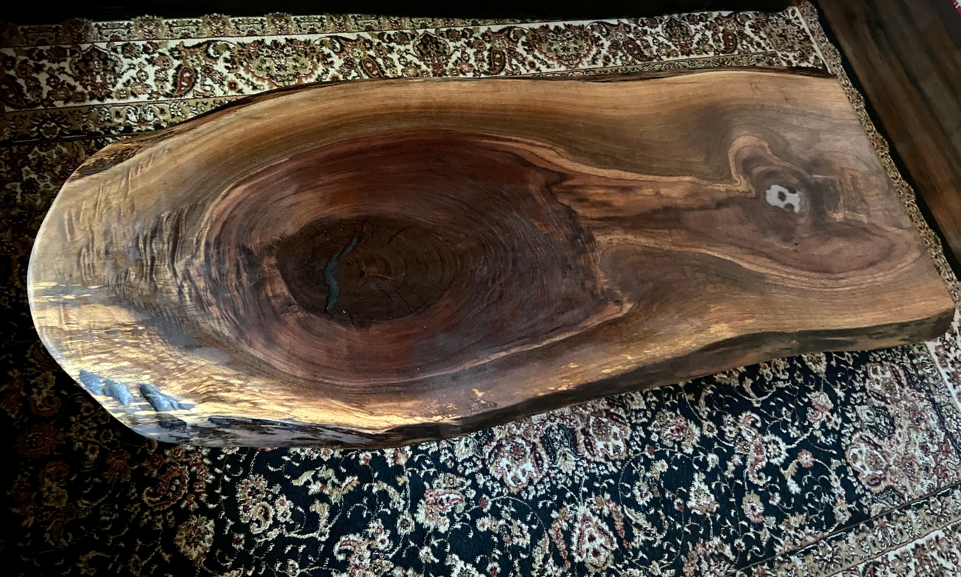 Live edge black walnut wood coffee table with gorgeous grain patterns, complete with a large knot, a smaller knot, and radial grain dancing around the entire table.Ultra unique oval rustic natural live edge black walnut coffee table offers natural walnut wood with gorgeous grain patterns, complete with a large knot, a smaller knot, radial grain dancing around the entire table, completed with curl and a long oval shape.